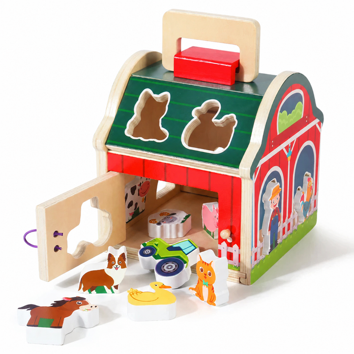 Wooden barn with its door open and animal and tractor pieces beside it.