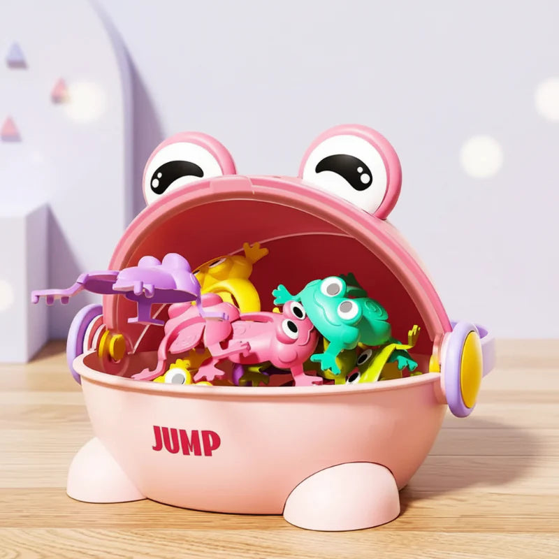 Open pink frog-shaped case holding colorful little jumping frogs.