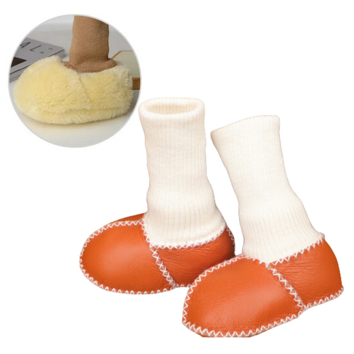 Orange baby slippers with tall white knit cuffs and white stitched seams