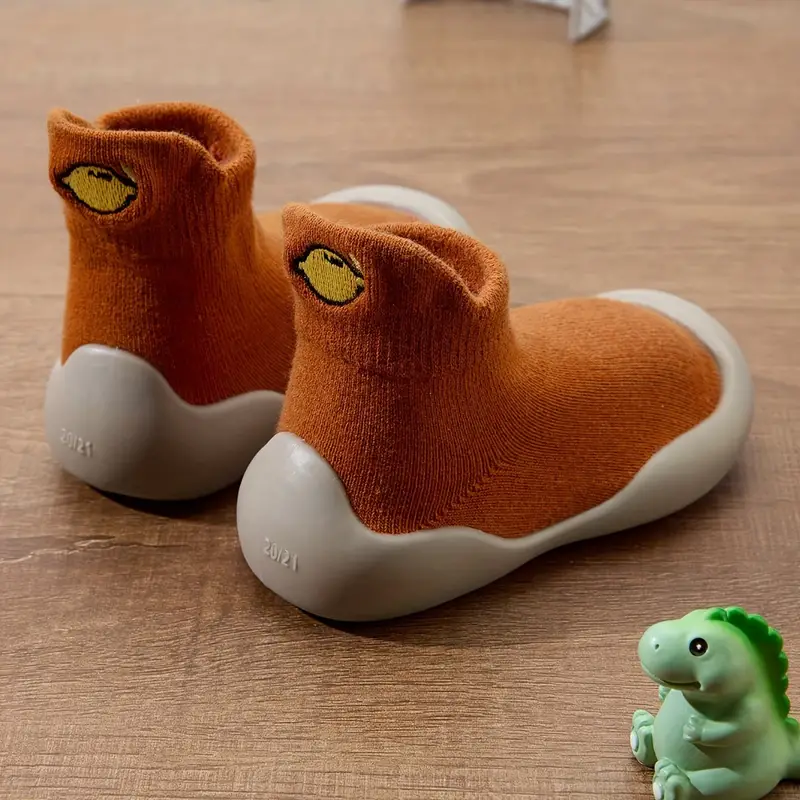 Orange baby shoes with citrus motifs, shown from the side and back