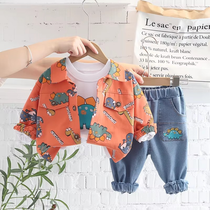 Orange dinosaur-print jacket with a white graphic T-shirt and blue pants on hangers