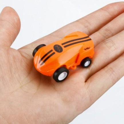Orange miniature stunt car with black stripes resting in an open palm