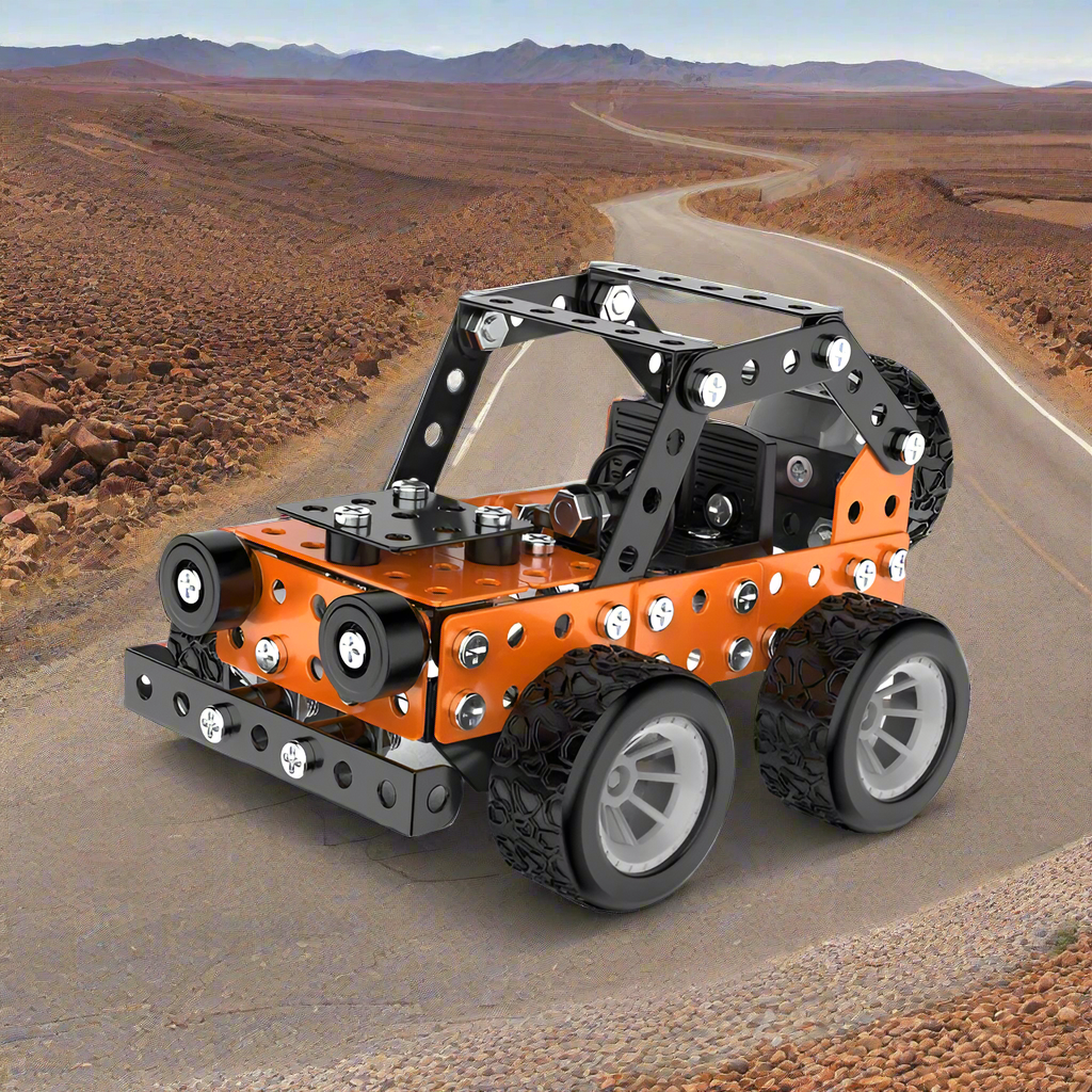 Orange and black metal off-road vehicle model with silver wheels on a desert-road backdrop