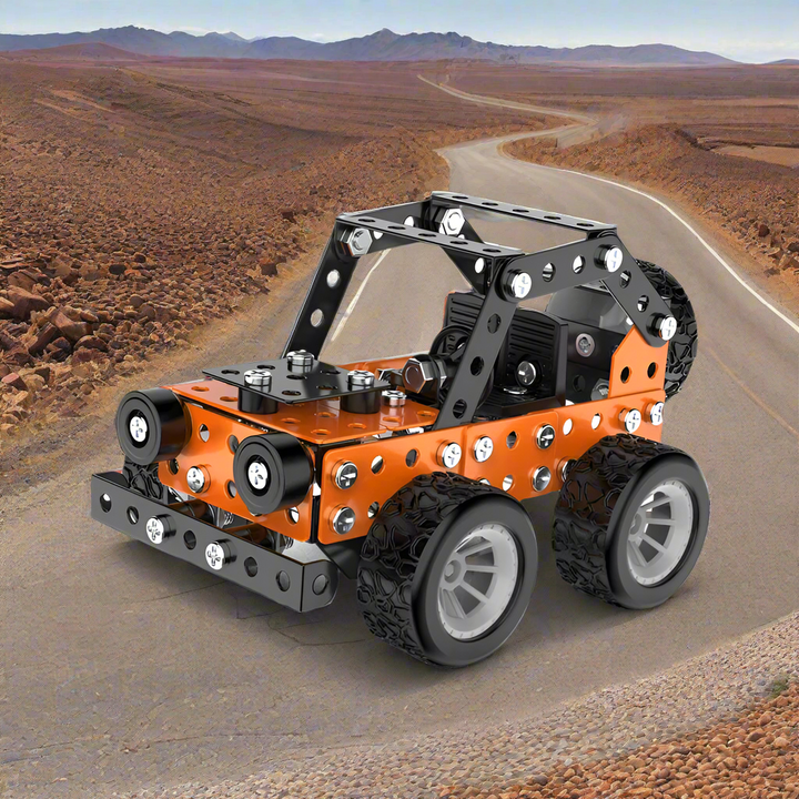 Orange and black metal off-road vehicle model with silver wheels on a desert-road backdrop