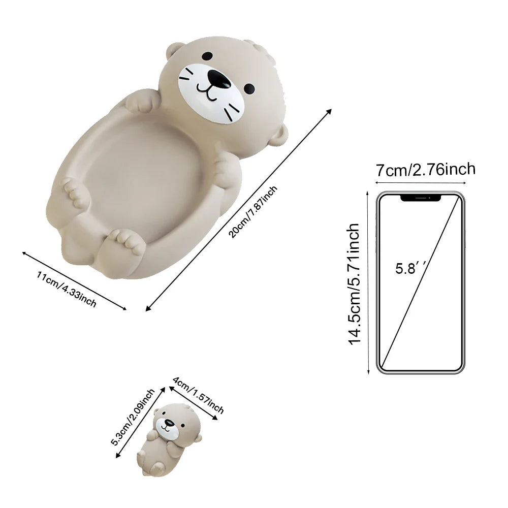 Otter bath toy dimensions shown beside a phone illustration for size comparison
