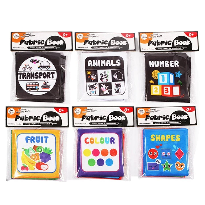 Six packaged fabric book designs featuring transport, animals, numbers, fruit, colors and shapes