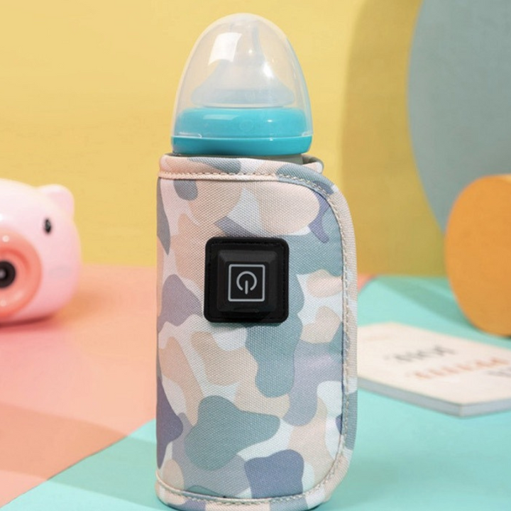 Pale camouflage bottle warmer around a blue-capped baby bottle.
