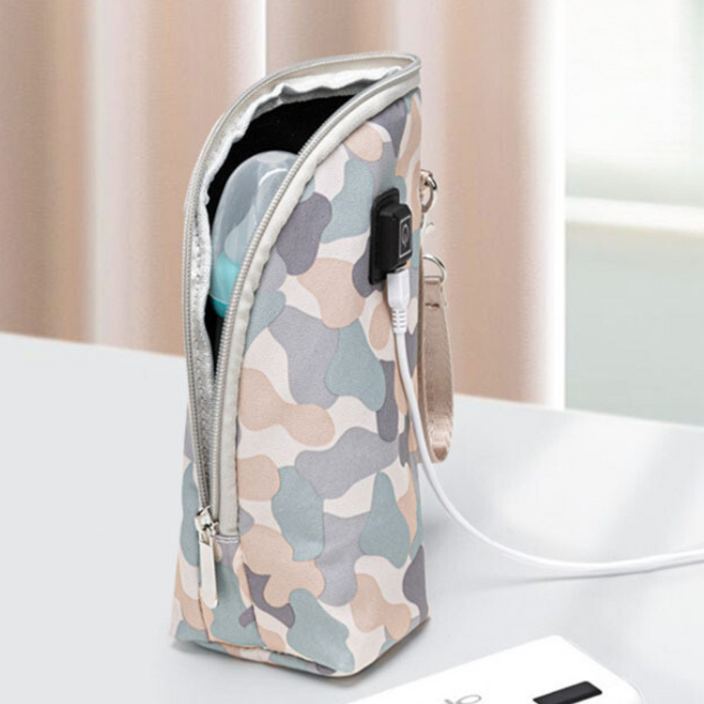 Pale camouflage zippered bottle warmer with wrist strap and USB cable attached.