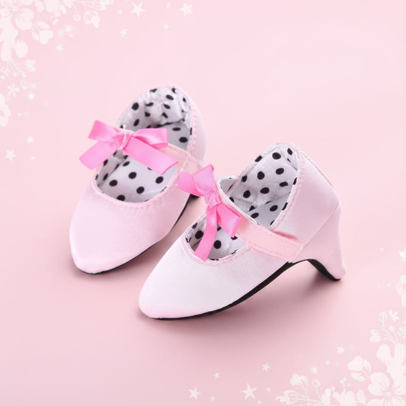 Pale pink baby shoes with small pink bows and polka-dot lining