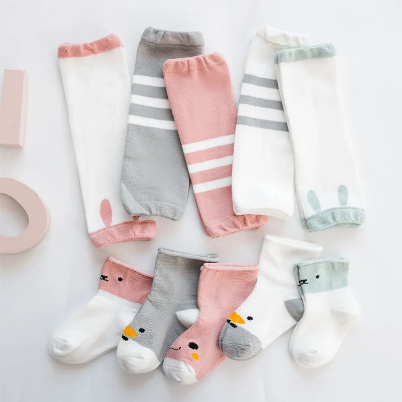 Baby leg warmers and coordinating animal-face socks in white, pink, gray, and pale green combinations.