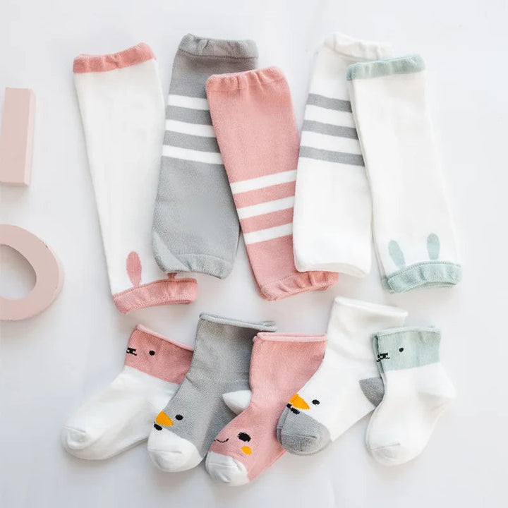Baby leg warmers and coordinating animal-face socks in white, pink, gray, and pale green combinations.