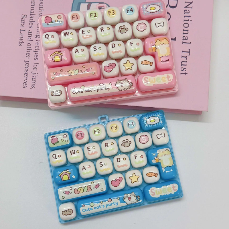 Light pink and light blue fidget keyboards with letters and cat-themed key designs