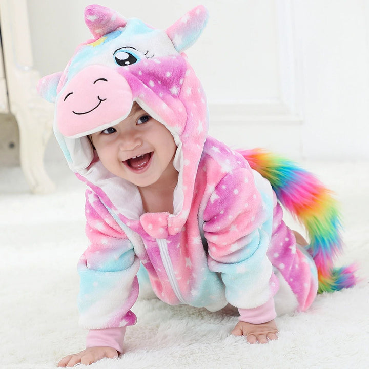 Pink and blue unicorn onesie with a star pattern and rainbow tail, shown on a crawling baby