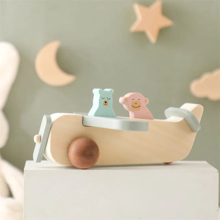 Side view of the three-piece wooden airplane with pink and green animal figures