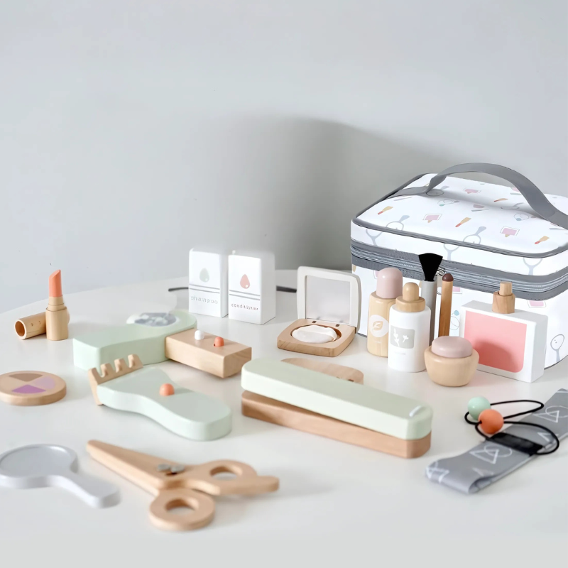 Pastel wooden beauty salon play set with toy styling tools, pretend makeup, and a zippered carry bag