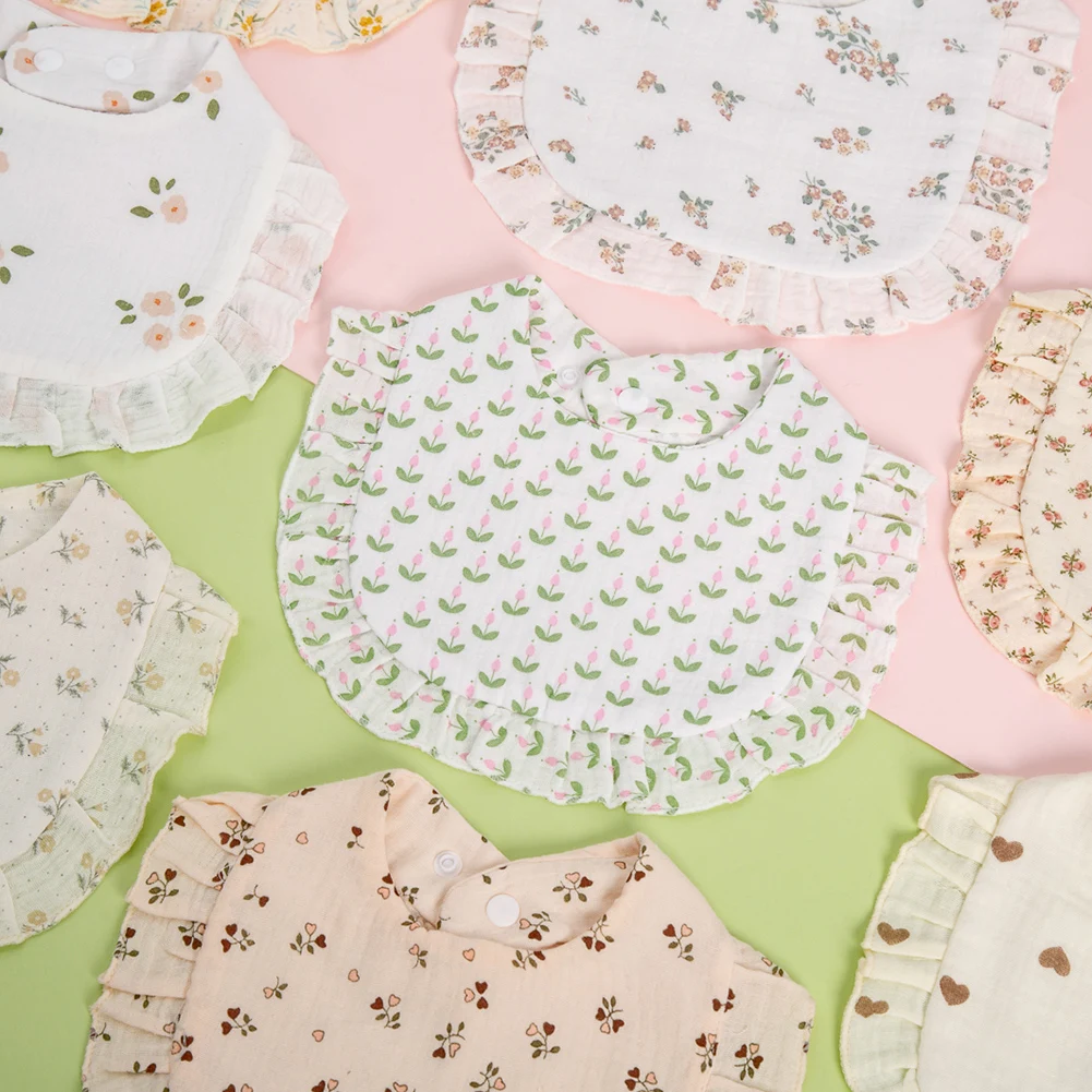 Ruffled baby bibs with floral, tulip, and heart prints arranged on pastel backgrounds
