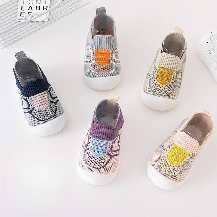 Five color options of patterned knit slip-on shoes with contrasting front accents