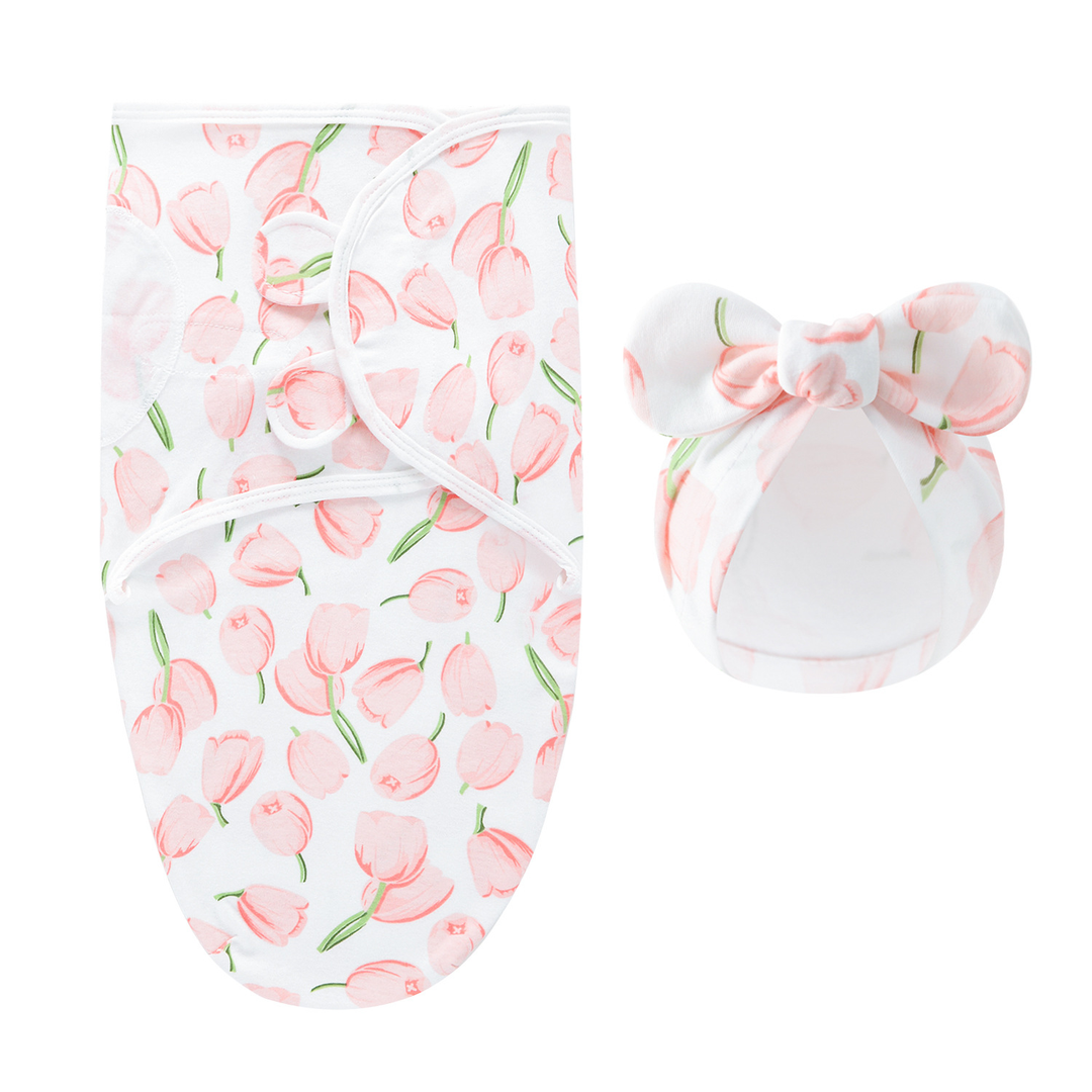 White swaddle blanket and matching bow hat with peach-pink tulips and green stems