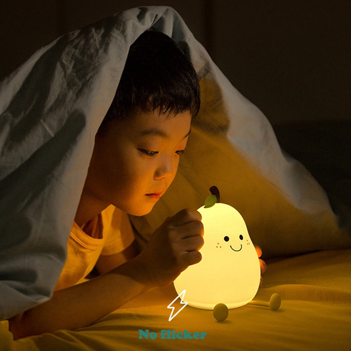 Child under a blanket beside a glowing pear-shaped night light