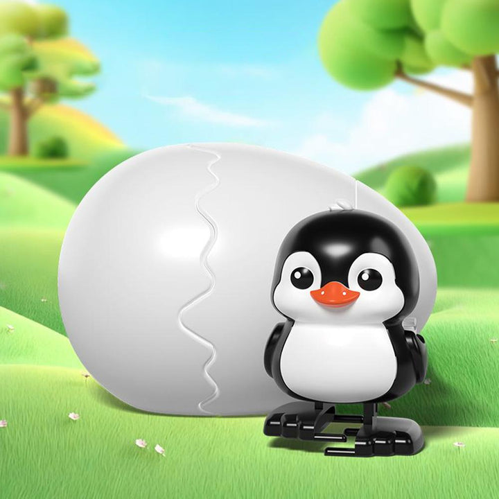 Black-and-white penguin wind-up figure with a white egg