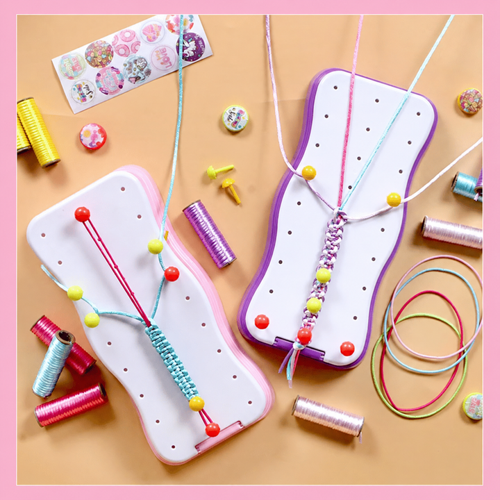 Pink and purple bracelet-making frames with colorful cords, pegs, and decorative pieces