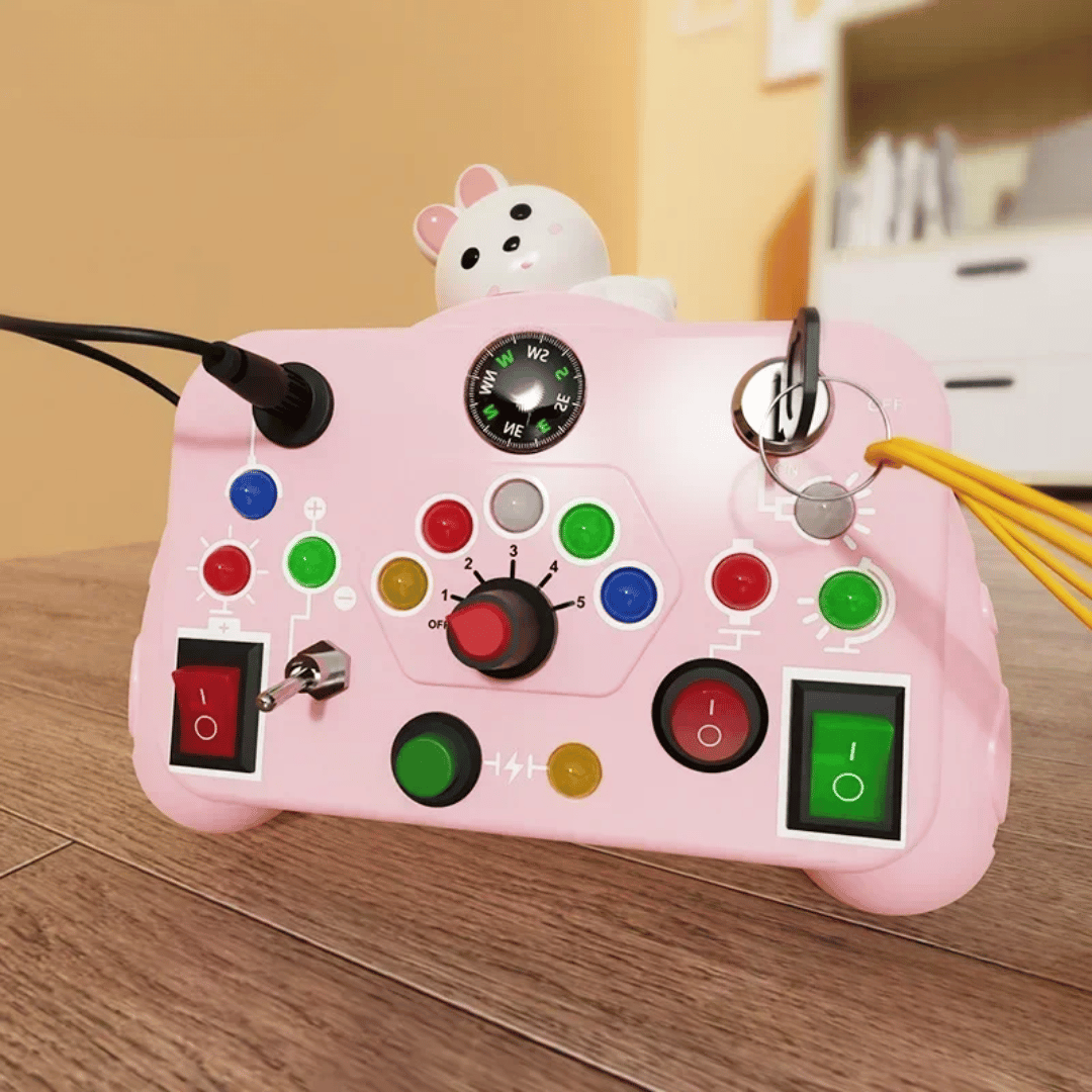 Pink activity board with an animal topper, rotary dial, key, buttons, and switches