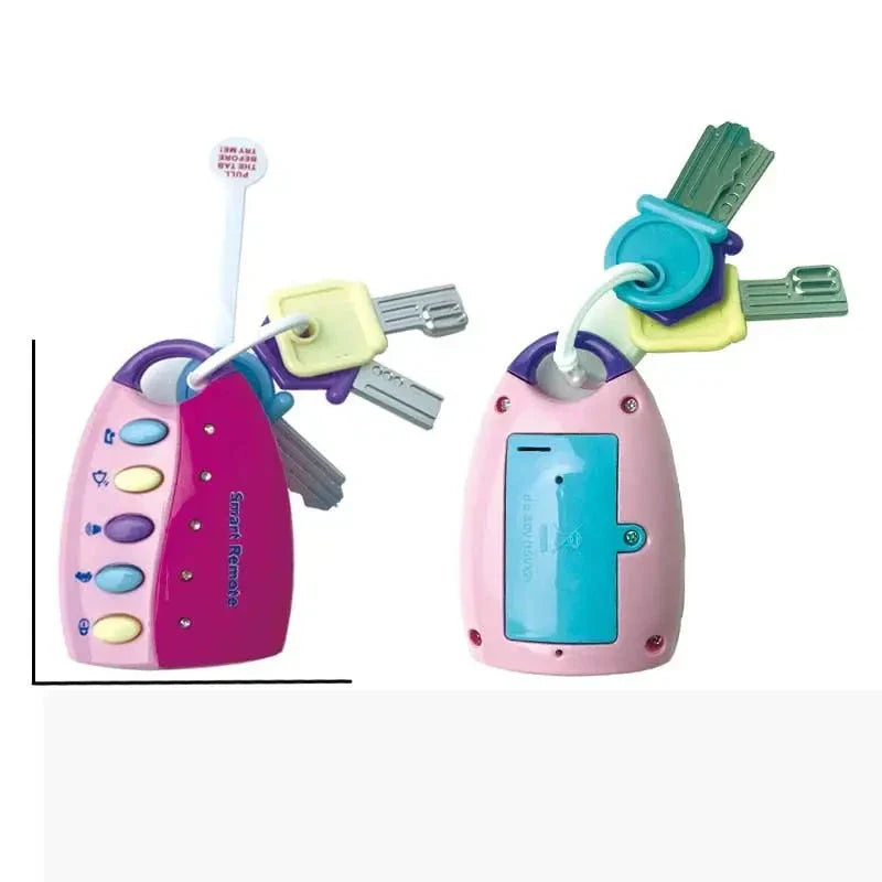 Front and back of the pink baby key toy, showing colorful buttons, attached keys, and battery cover