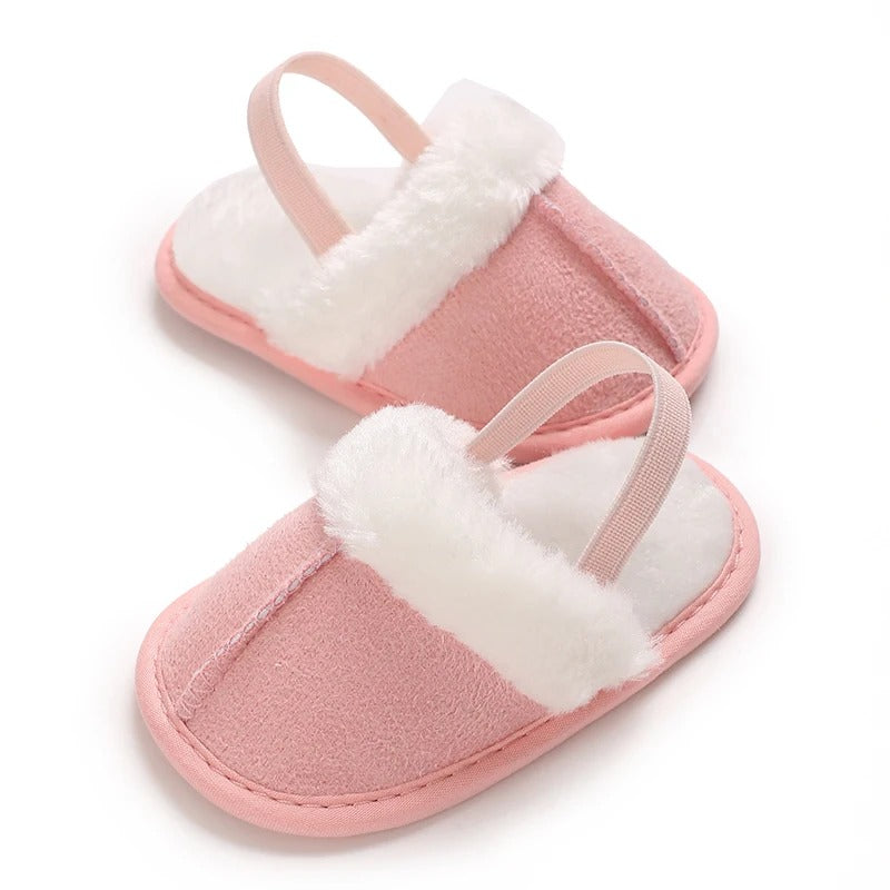 Pink baby slippers with white plush trim and matching pink heel straps