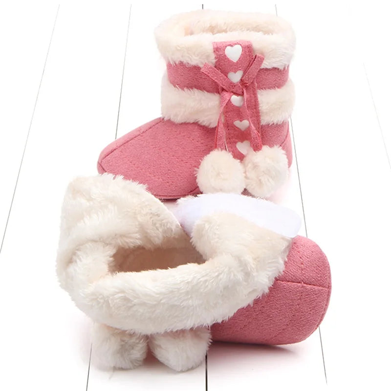 Pink baby snow boots with a close view of the soft lining and fluffy cuff