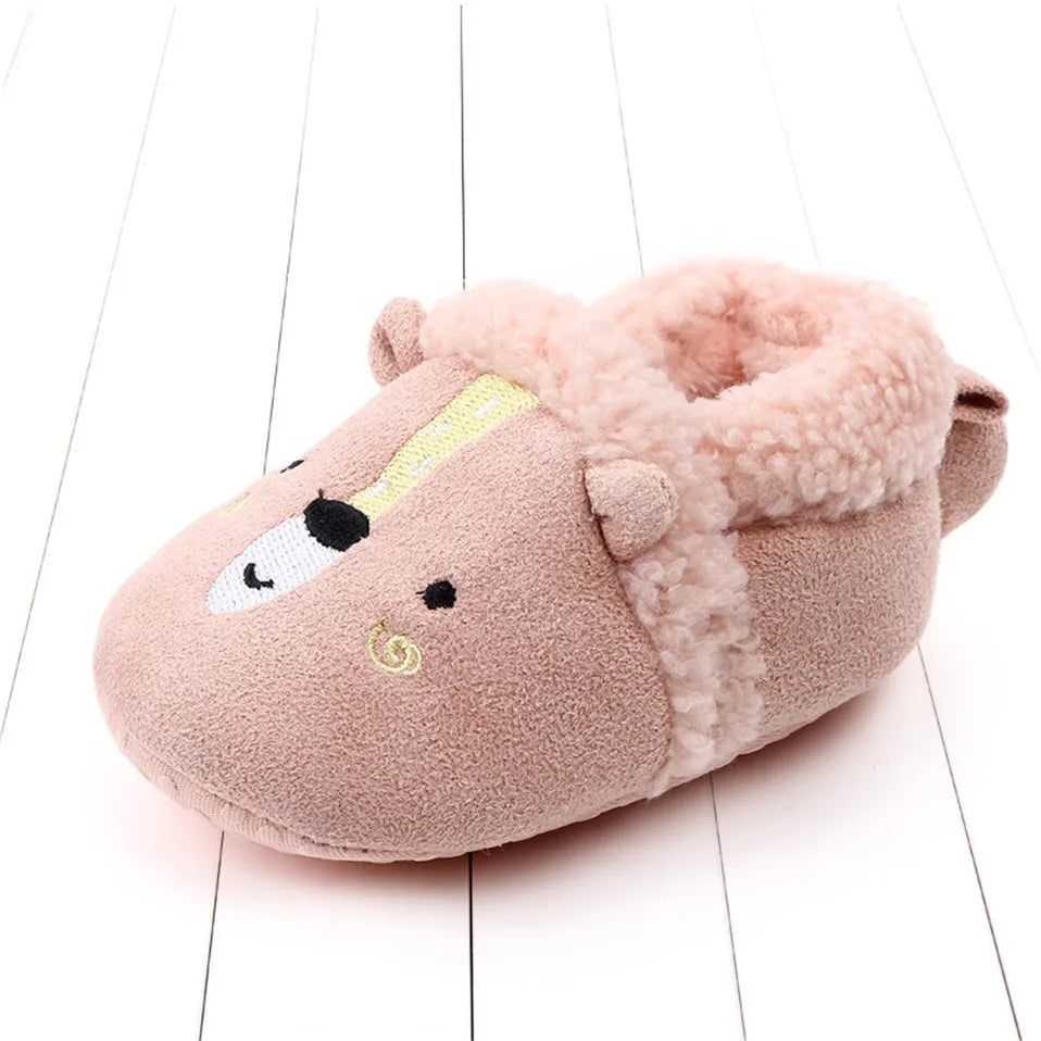 Pink bear baby slipper with a stitched face and pale fuzzy trim.