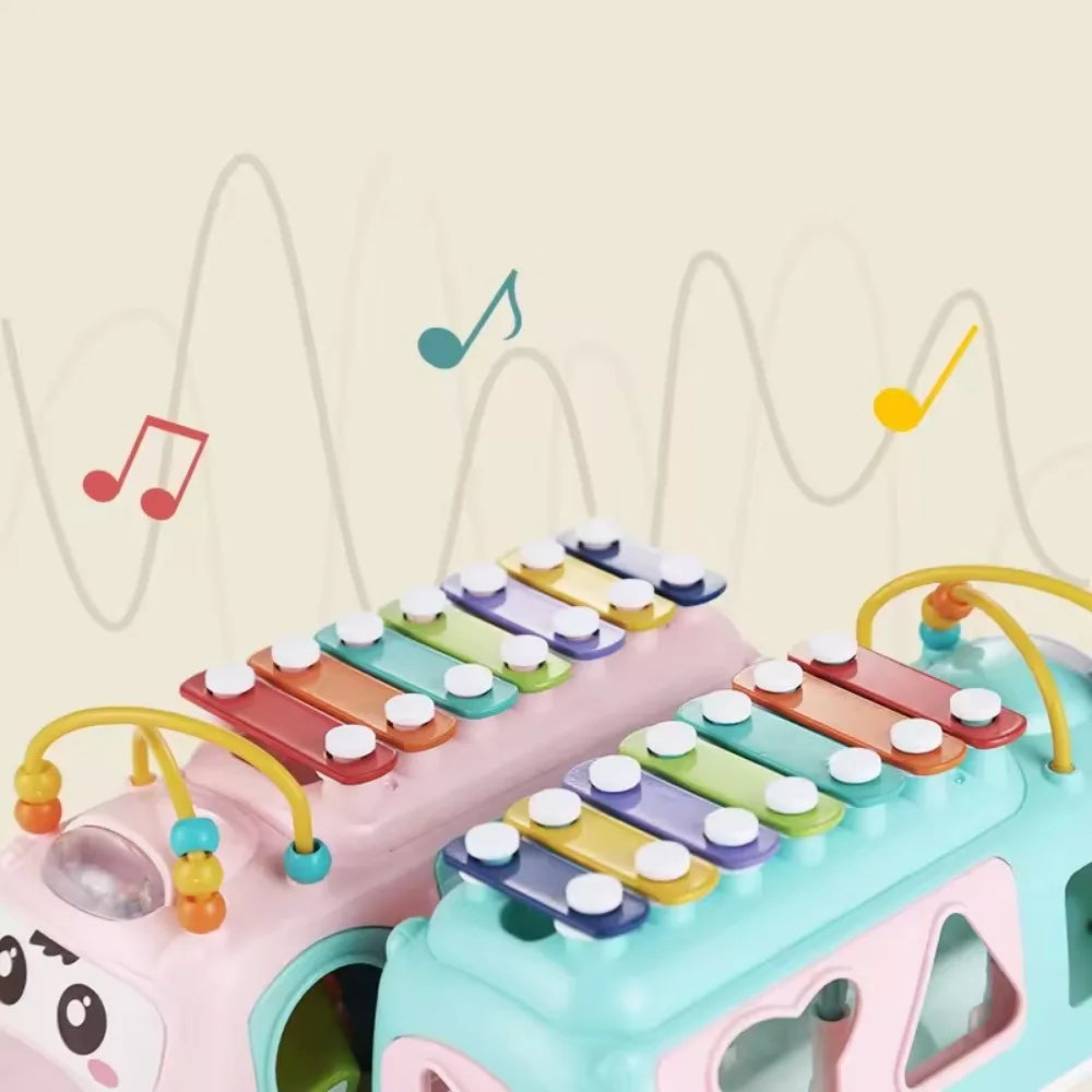 Close-up of colorful roof keys and bead tracks on pink and blue musical toy buses