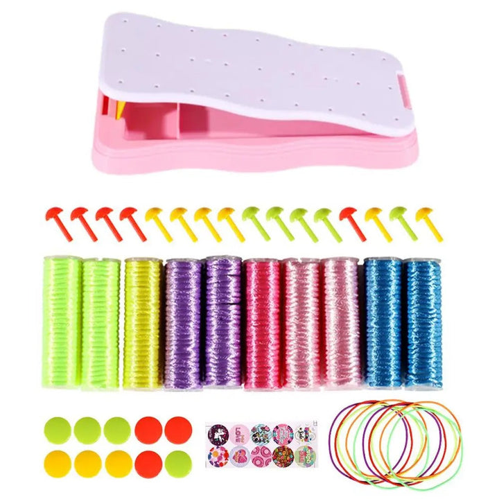 Pink braiding frame with colorful cord spools, pegs, and round decorations