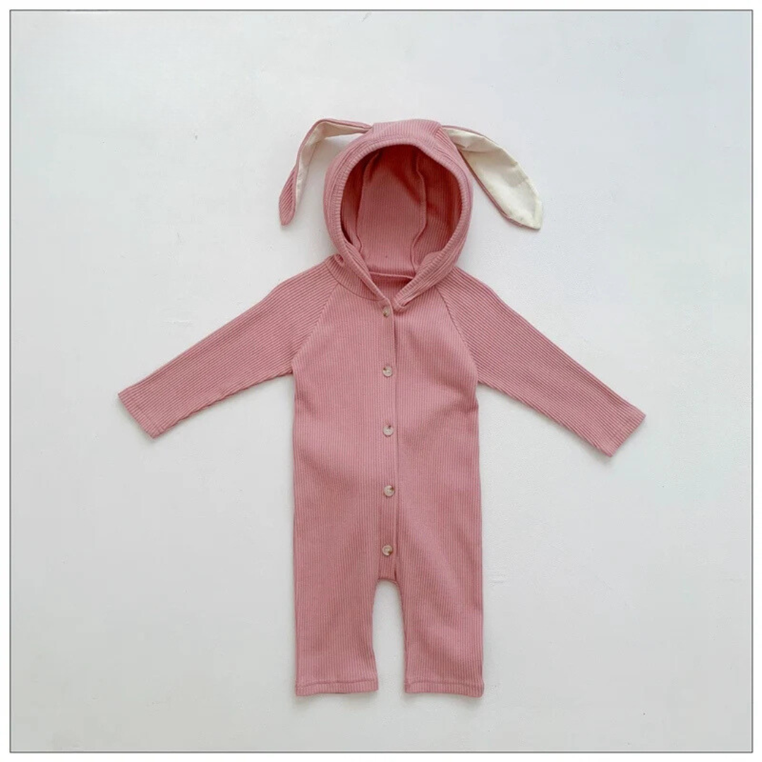 Pink cotton baby romper with a bunny-ear hood, long sleeves and a button front