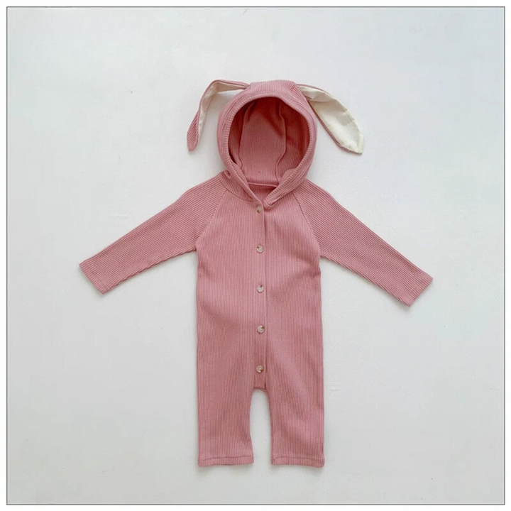 Pink cotton baby romper with a bunny-ear hood, long sleeves and a button front