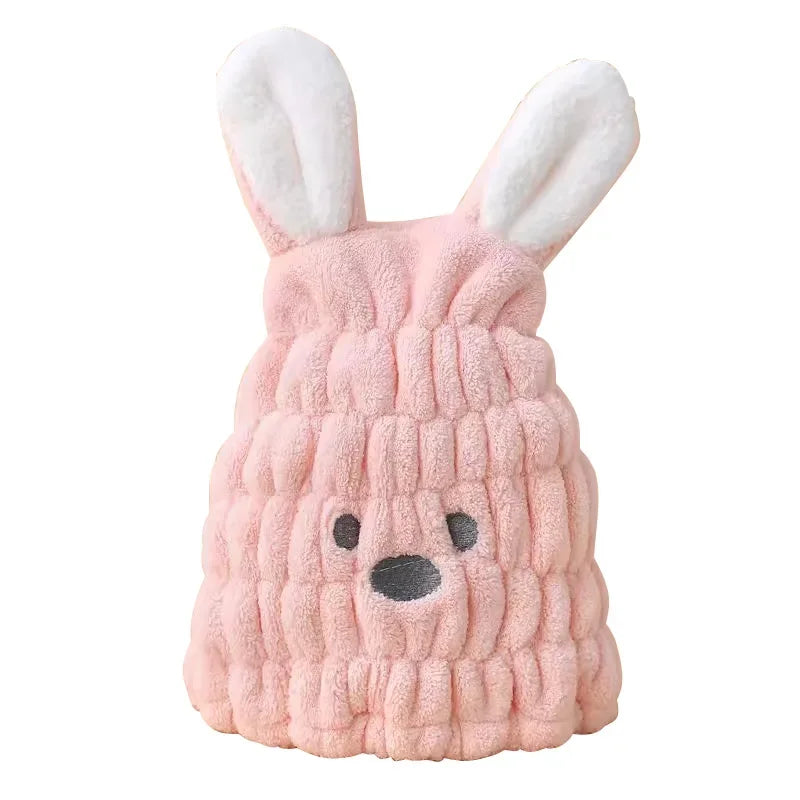 Pink bunny hair-drying cap with white ears against a white background