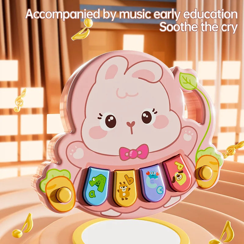 Pink bunny animal piano with four colorful keys and a carrot-shaped side handle