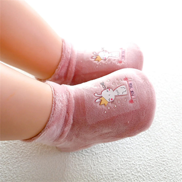 Pink bunny-print sock shoes worn on a child&