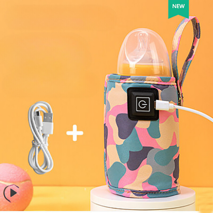Pink multicolor camouflage bottle warmer holding a capped bottle with USB cable attached.