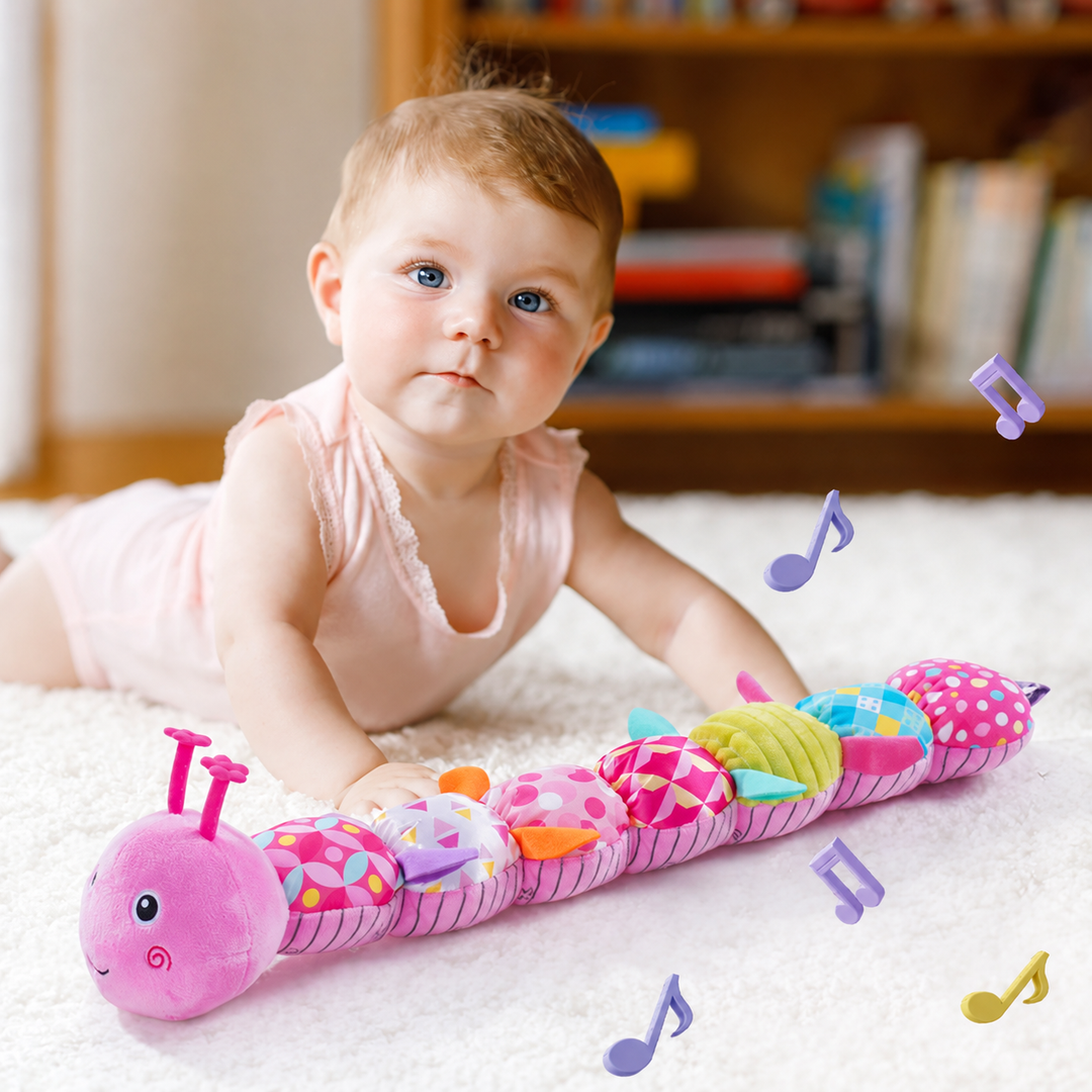 Baby beside a pink caterpillar rattle with illustrated musical notes