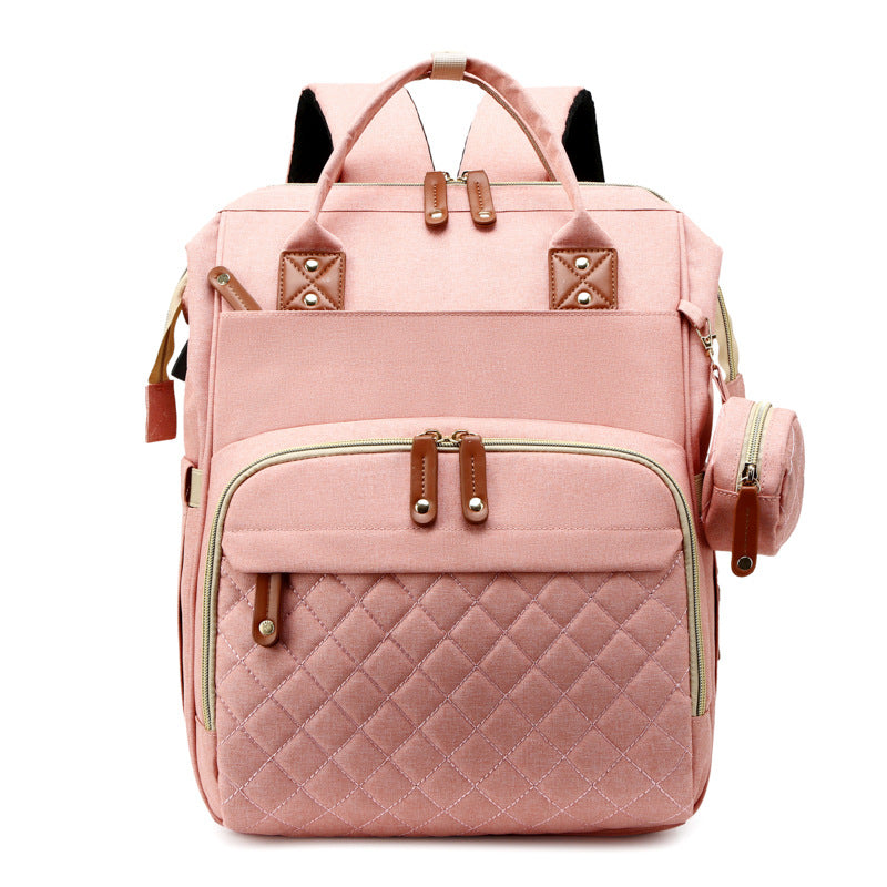 Pink diaper backpack with a quilted front pocket and matching round side pouch