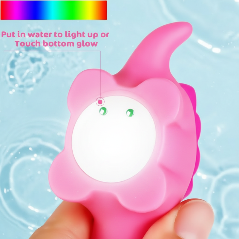 Underside of a pink dinosaur bath toy showing two activation contacts