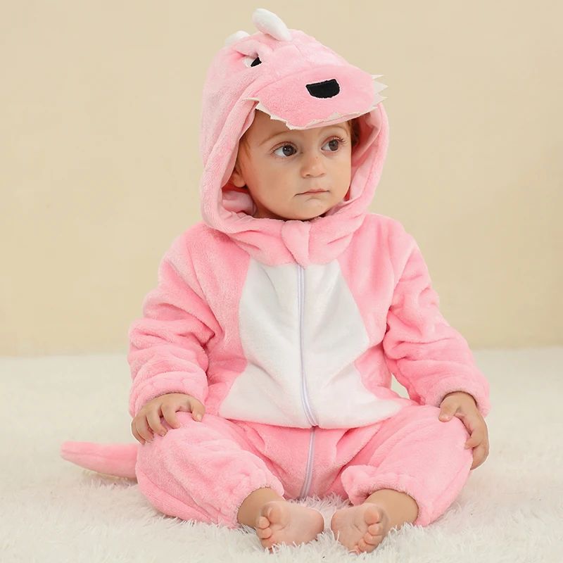 Baby seated in a pink dragon onesie with a white belly and matching tail