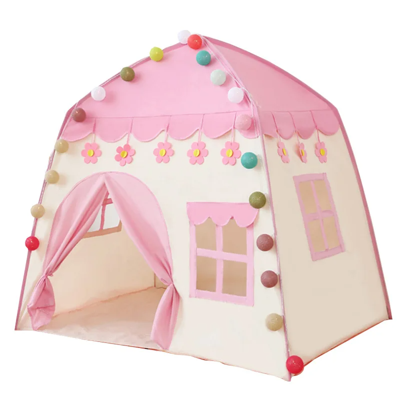 Pink castle play tent with flower trim, tied-back curtains, and decorative ball lights