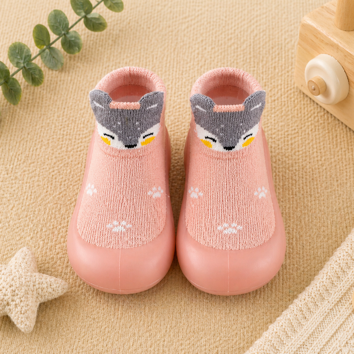 Pink knitted sock shoes with fox faces and matching pink soles.