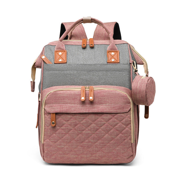 Pink-and-gray diaper backpack with a quilted front pocket and pink side pouch