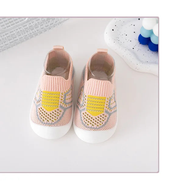 Pair of pink knit slip-on shoes with yellow accents and white soles
