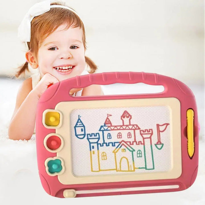 Child holding a pink magnetic drawing board with a multicolor castle drawing