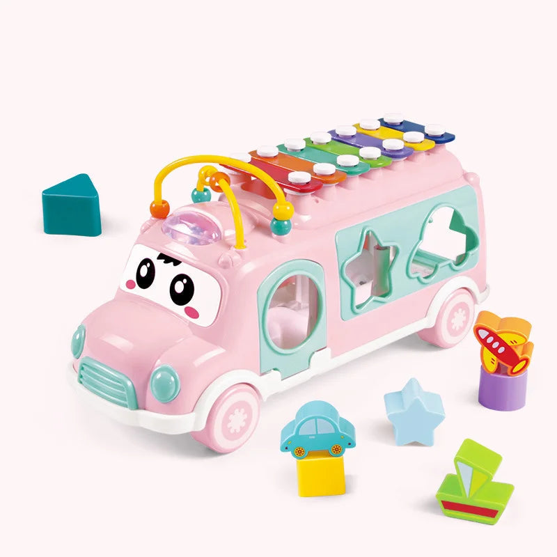 Pink musical toy bus with colorful roof keys, bead tracks, and matching shape blocks