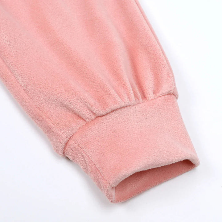 Pink pants leg showing gathered fabric above the ankle cuff