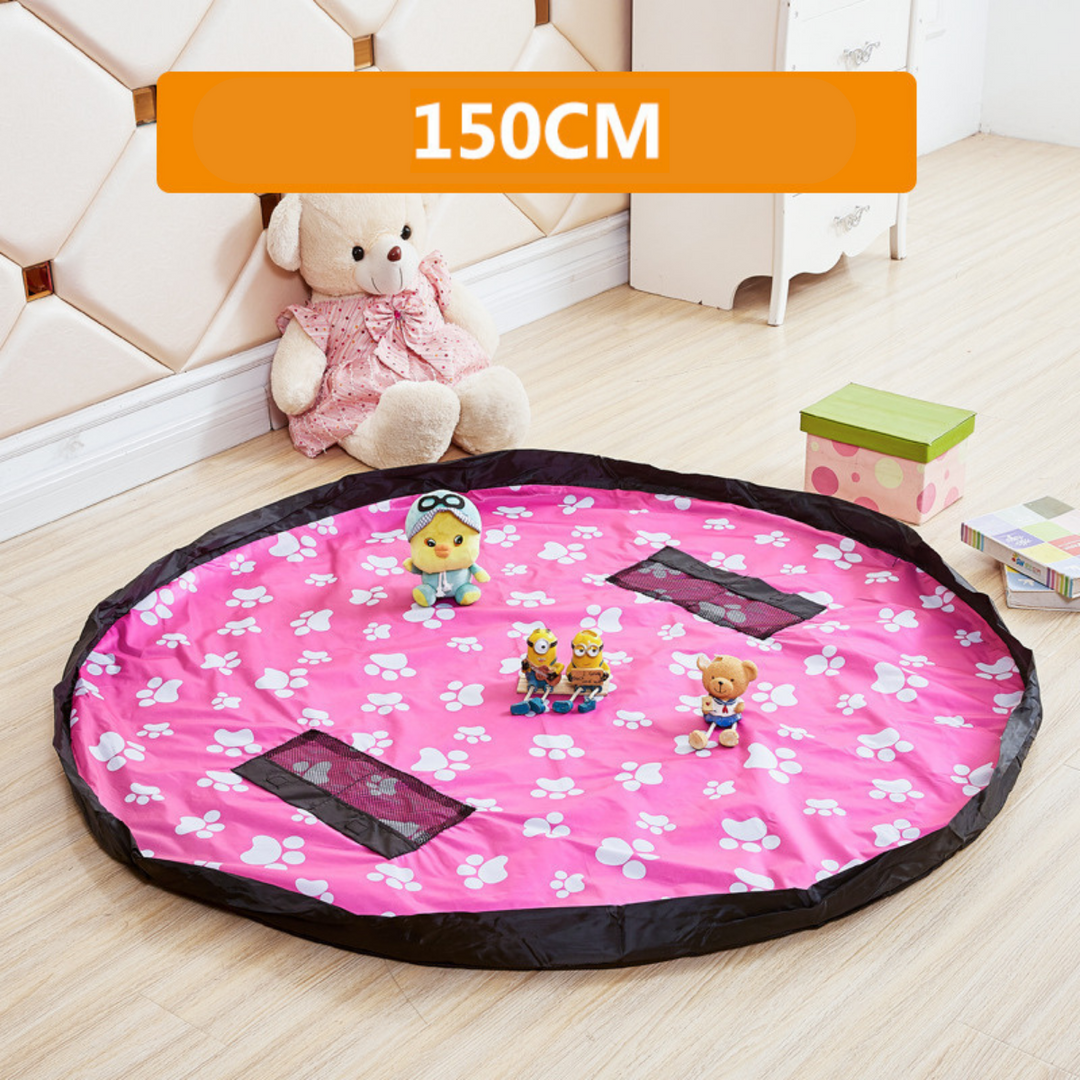 Pink round play mat and storage bag with white paw prints and a black border.